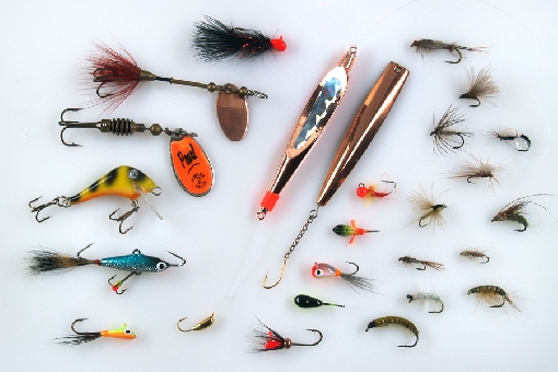 Whitefish lures. Left vertical row: MA Mini-Leech, Myr, Rublex Celta, Seniori, small balanced lure and MA Mikro-Mutu. In the middle: two vertical jigs and different kind of mormyshkas. In the right: flies for whitefish. 